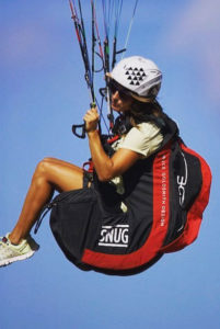 Iris flies her mono glider by the beach, where the trade winds hit the island
