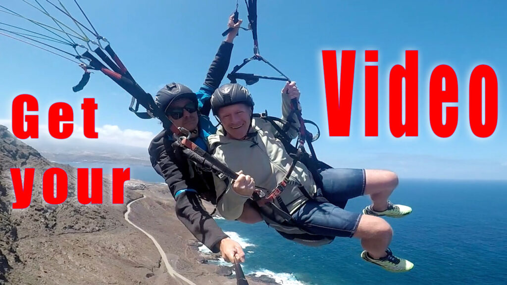 Paragliding video in Las coloradas tandem promotional qit the pilot and passenger flying over las coloradas mountain and the ocean on the background